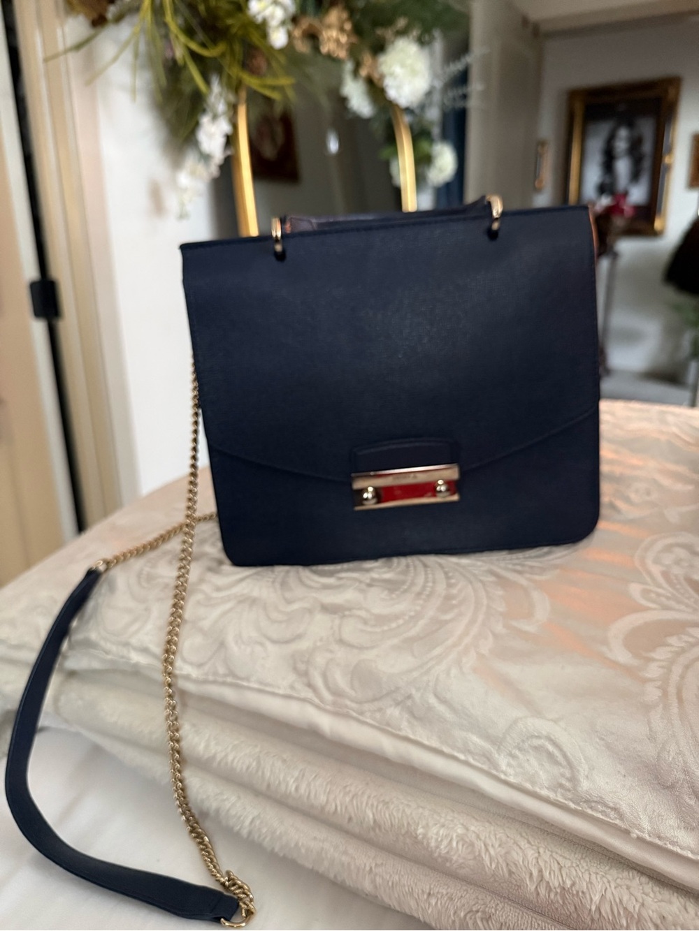Furla navy crossbody with gold chain and top handle